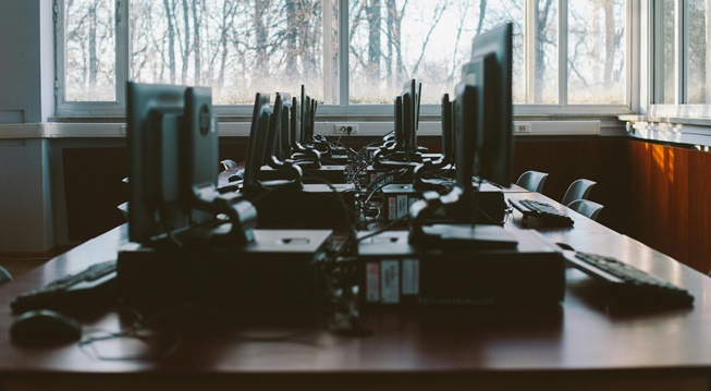 A row of computers on office desks